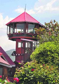 The Chalets Naldehra, a resort on the outskirts of Shimla, has set up a revolving restaurant. The octagonal wooden structure with ceiling to floor clear glass windows provides an enchanting view of the green mounain ranges. Photo: Amit Kanwar