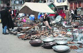 Earning livelihood: A vendor sells tools on a roadside in Srinagar on Tuesday