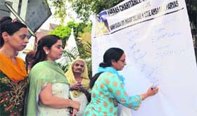 Women take part in a signature campaign seeking speedy justice for the five-year-old rape victim in Ludhiana on Tuesday