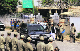 Paramilitary troops stand guard as a vehicle carrying former President Pervez Musharraf leaves an anti-terrorism court in Rawalpindi on Tuesday.