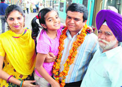 Major Singh, one of the 35 crew members of a stranded ship, is welcomed by his family at Amritsar railway station on Wednesday. 