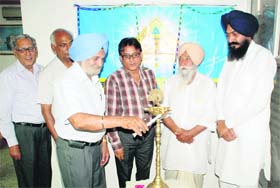 A customer of Allahabad Bank does the honours by lighting the ceremonial lamp to mark the 149th Foundation Day of the bank