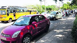 Parents wait on the V-road curve outside St Josephs School