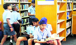 Students of Smart Wonders School, Mohali, browse through books during their visit to British Library in Chandigarh on Wednesday