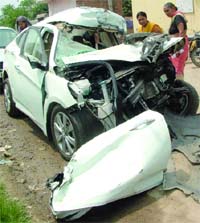 The mangled remains of Hyundai Verna car which rammed into a truck at Swaroop Nagar in northwest Delhi on Wednesday.