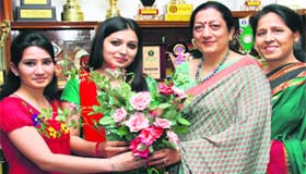 Principal Atima Sharma congratulates a student who got the third position in the GND merit list