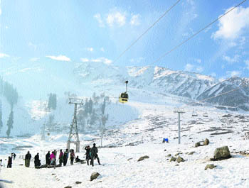 Tourists await their turn to take a ride on the cable car in Gulmarg on Wednesday.