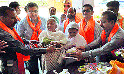 Activists of the Rashtrawadi Shiv Sena distribute items of daily use among inmates of an old-age home in Jammu on Wednesday