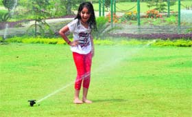 Having a splash: A girl plays with water at a park in Ludhiana