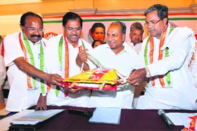 Senior Congress leaders & Union Ministers A K Antony and Veerappa Moily with party's Karnataka chief G Paramswara and Siddaramaiah release the party's manifesto for the Assembly elections in Bangalore on Wednesday