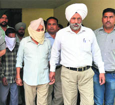 ACP Baldev Singh Chauhan and his aide Pappu in VB custody in Ludhiana on Wednesday. 