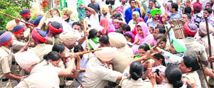 Police using force to stop protesters from entering Punjab Finance Minister Parminder Dhindsas residence in Sangrur on Wednesday. 