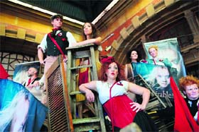 A choir and actors, clad in revolutionary period costumes, perform scenes from the opera Les Miserable for commuters at Sydney's Central Train station on Wednesday