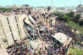 People and rescuers gather after an eight-storey building housing several garment factories collapsed in Savar, near Dhaka, Bangladesh, on Wednesday