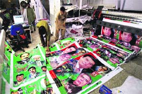 FINE PRINT: Workers print banners of candidates for the upcoming parliamentary elections at a local press in Rawalpindi