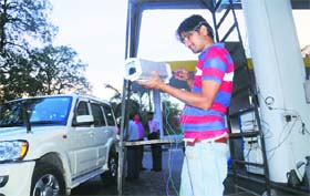 A worker checks a CCTV camera while installing it at a petrol pump at Sector 9 in Chandigarh on Thursday