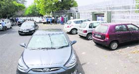 Vehicles parked along the boundary wall of DAV College