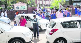 A staff of Carmel Convent school manning the traffic outside the main gate