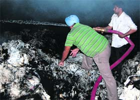 Firemen try to douse flames in a cotton godown in Ambala
