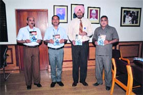 Vice-Chancellor Lt-Gen (retd) DDS Sandhu (third from left), accompanied by Prof BR Saini, Chairman, Law Department, (extreme left), Dr Sunil Yadav, Assistant Prof Law Department, (second from left) and Prof VK Razdan, Dean, Law Faculty (extreme right), releases the book A Text Book on Law of Industrial Disputes in his office on the Kurukshetra University premises