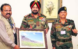 Army Chief General Bikram Singh with National Photo Award winner Shib Narayan Acharya In Jammu on Wednesday.