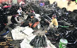 Workers assemble cycle parts at a factory in Ludhiana. a file photo