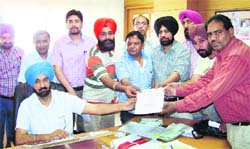 A delegation of the Math Teachers Association, Punjab, submitting a memorandum of demands to the Director General of School Education, Kahan Singh Pannu. A Tribune photograph