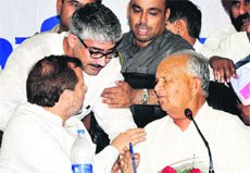 State Congress chief Phool Mullana (right) and MP Arvind Sharma argue with a party worker during a DCC meeting in Karnal on Friday. 