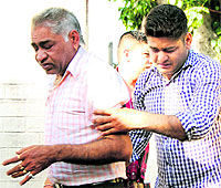 The wailing father and brother of Raghav Sharma in Jalandhar on Friday