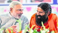 Gujarat CM Narendra Modi and yoga guru Ramdev at Haridwar on Friday. A Tribune photograph
