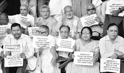 Left party MPs stage a protest against the chit fund scandal in West Bengal, at Parliament House in New Delhi on Friday. Tribune photo: Mukesh Aggarwal