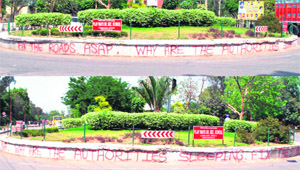 Residents exhibit their anger on damaged roads in the city by writing on the kerb of YPS Chowk in Patiala on Friday. 