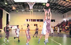 Players in action in a match during the 27th All-India Golden Jubilee Basketball Tournament in Dehradun on Friday. Tribune photo: 