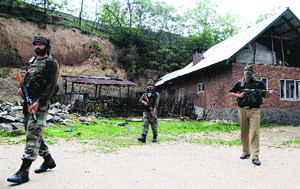 The Army and the police conduct a search operation at Sopore in Baramulla district on Saturday.