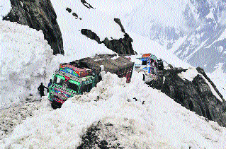 Trucks being pulled out of snow near Zojila on the Srinagar-Leh national highway on Thursday.