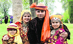 Tourists in Kashmiri traditional dresses at Nishat Bagh Mughal Garden, on the Dal Lake, in Srinagar on Saturday