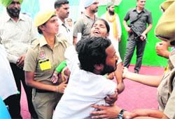 The differently abled couple being pushed around at a function in Bathinda on Saturday. Tribune photo: Pawan Sharma