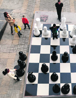 Children and their parents play giant chess in Yerevan, Armenia, on Saturday.