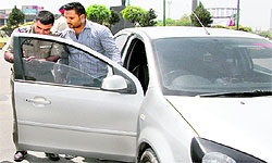A policeman removes black films from a four-wheeler on a road in Amritsar