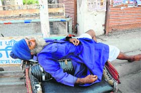 Stealing forty winks: A rickshaw-puller takes a nap on a warm afternoon in Bathinda
