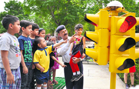 A traffic policeman apprises students of traffic rules at Chandigarh Traffic Park.