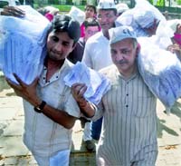 Members of the Aam Aadmi Party Manish Sisodia and Kumar Vishwas with other supporters arrive at Chief Minister Sheila Dikshits residence to give her complaint letters and electricity bills, in New Delhi on Sunday. 