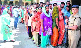 Voters stand in a queue to cast their votes in the civic elections in Haridwar on Sunday.
