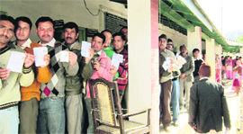 Voters line up at a polling station in Pithoragarh on Sunday.