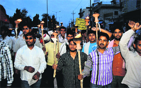 Dismissed employees of the Maruti Suzuki Manesar plant take out a torchlight procession in Kaithal on Saturday night.