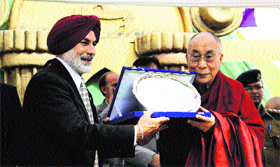 Capt GS Dhillon, Principal of Dalhousie Public School, presents a souvenir to the Dalai Lama at Dalhousie on Sunday.