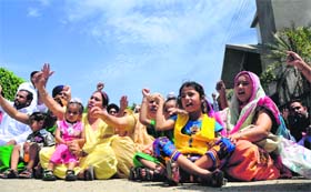 Family members of unemployed linemen, including women and children, stage a dharna in Ludhiana on Sunday