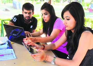 Radhika (center) with her friends reading an e-book. 