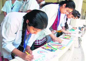 Students participate in a poster-making competition during the district-level workshop organised by the Health Department in Amritsar on Monday