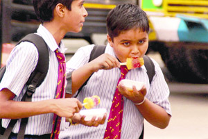 With temperature soaring, school students lap up ice-candies on their way back home in Bathinda on a hot Monday afternoon.